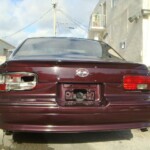 Before and after photographs of a damaged Chevy Impala that was repaired by Elite Paint & Body Shop in West Palm Beach, Florida.